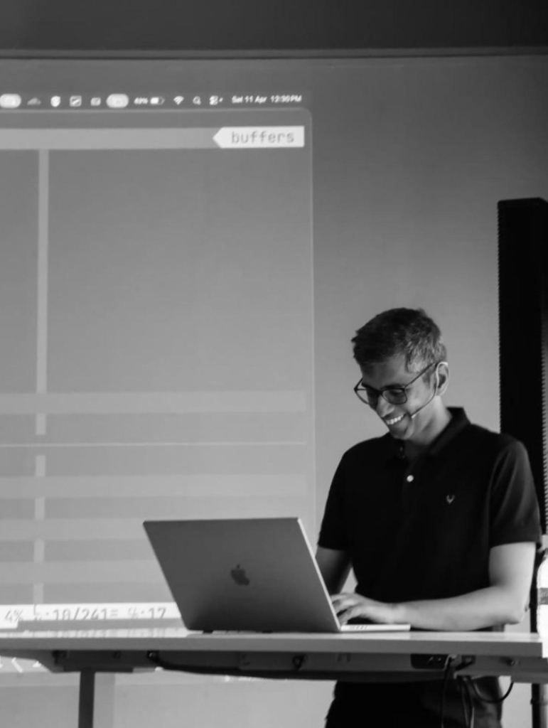 Episode 3 speaker portrait in black and white at podium