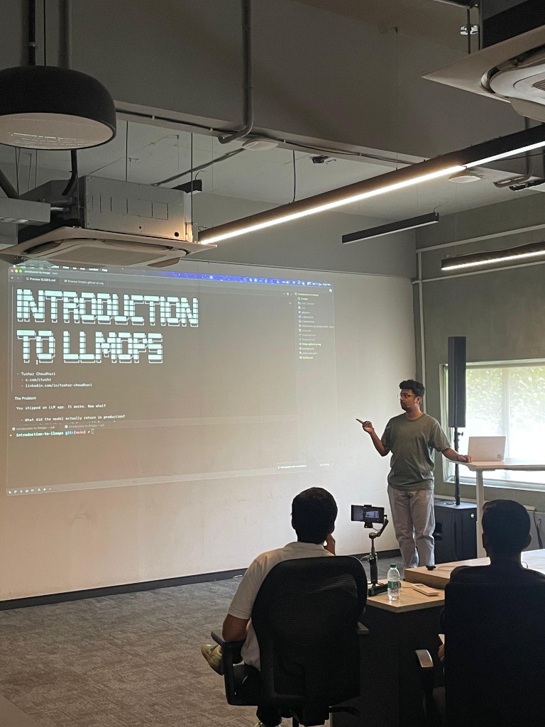 Episode 3 speaker presenting with Introduction to LLMOps slide on projector